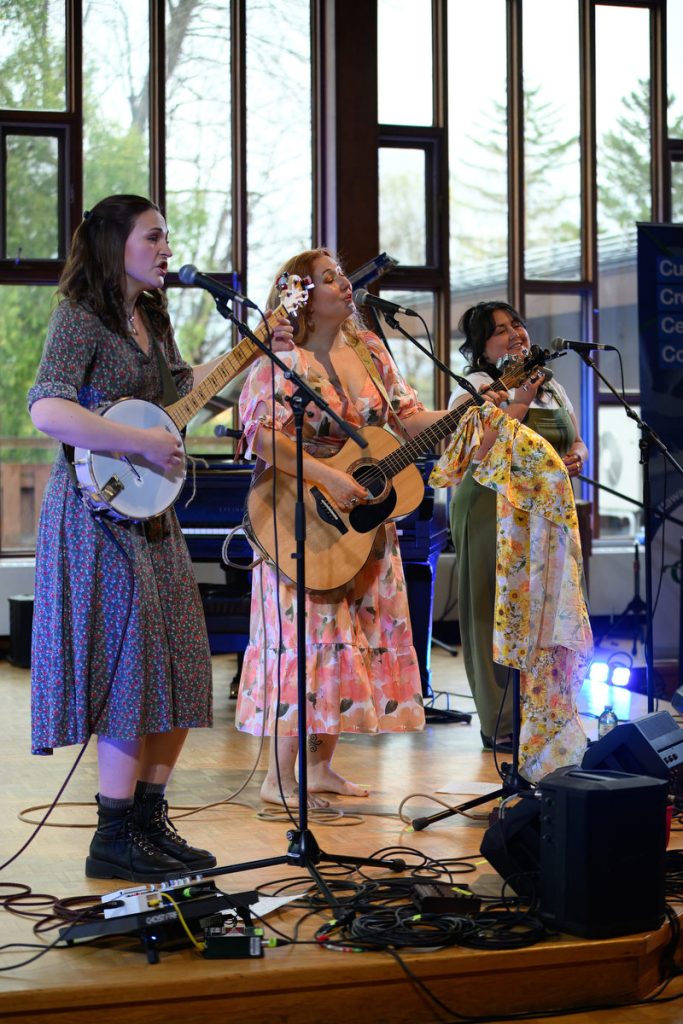 Jessica Pearson and the East Wind perform in front of the beautiful windowed backdrop of the First Unitarian Church