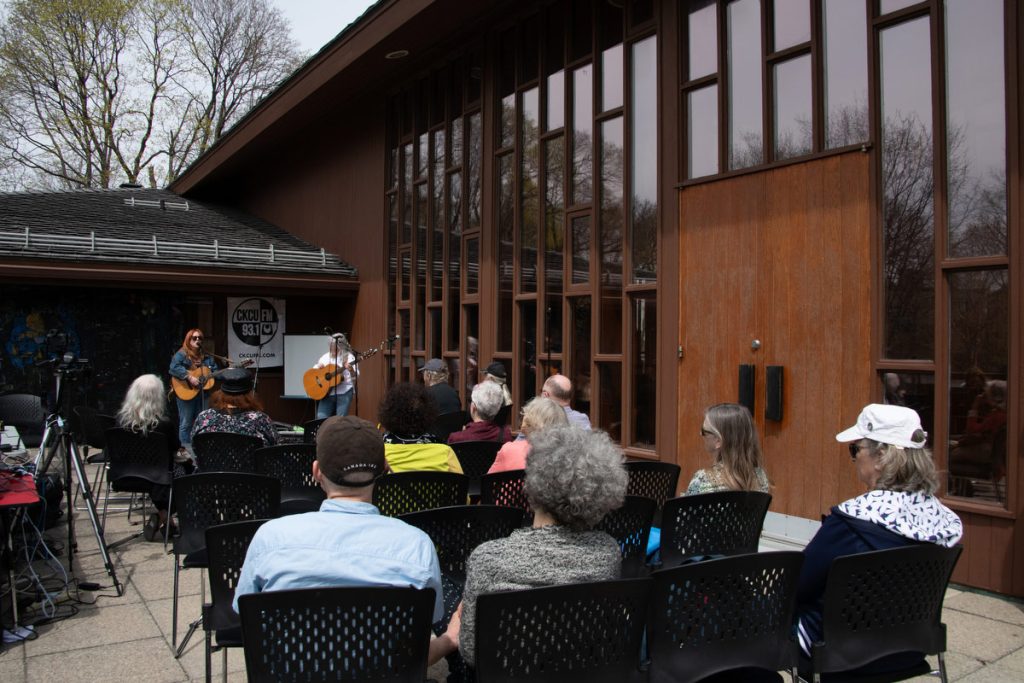 A rousing outdoor performance on the upper deck of the First Unitarian Church, where you can see the beautiful windows behind the performer