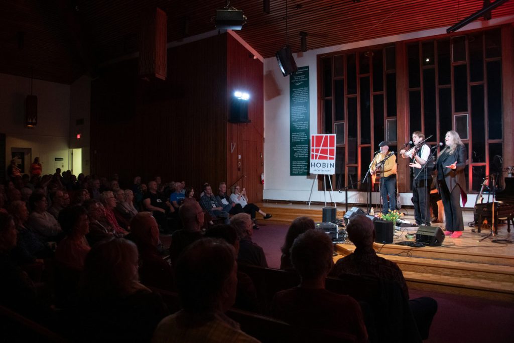 Connie Kaldor and her band perform in the wonderful space at First Unitarian Church, and on stage you can see the Hobin Architecture sign on an easel.  Hobin is the title sponsor of the festival.