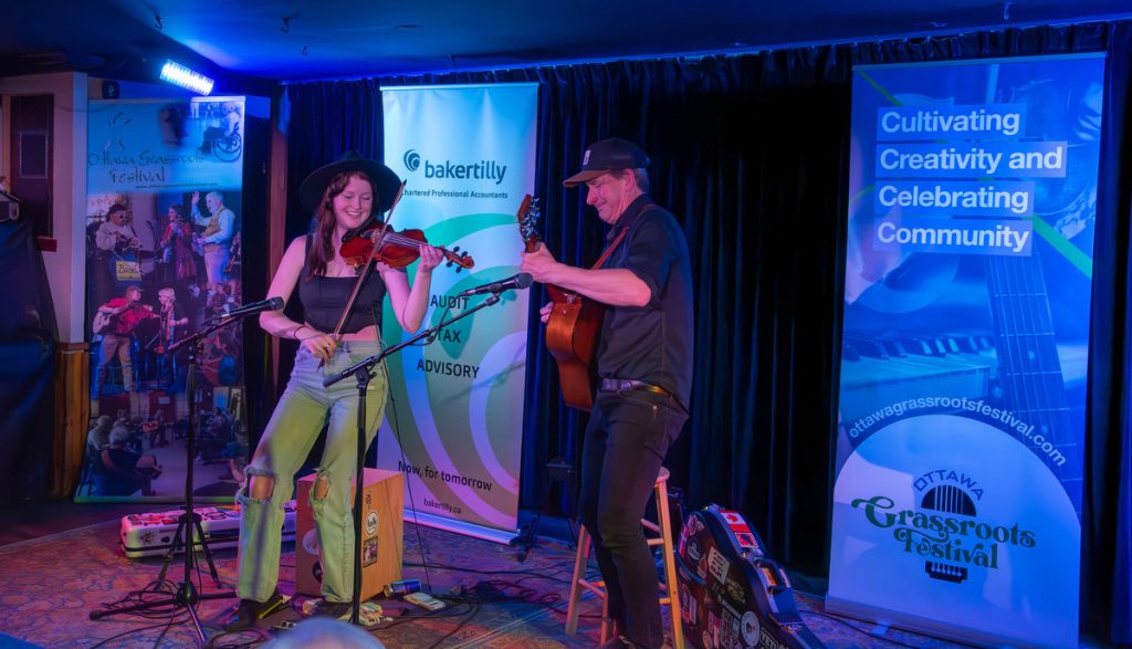 Irish Millie and Murray playing lively tunes on stage at Irene's Pub for the Sunday of the Ottawa Grassroots Festival