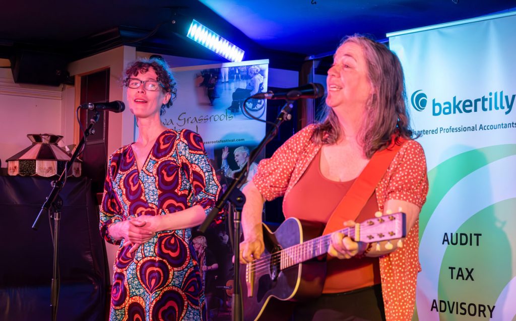 Libby Hortop and Christine Graves singing on stage at Irene's Pub